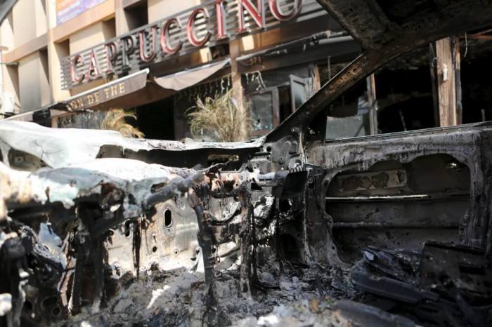 The front of Cappuccino restaurant is seen from a burned-out car after an attack on the restaurant and the Splendid Hotel, in Ouagadougou, Burkina Faso, January 18, 2016.