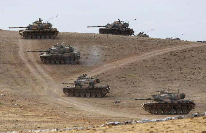Turkish army tanks take up position on the Turkish-Syrian border near the southeastern town of Suruc in Sanliurfa province September 29, 2014.