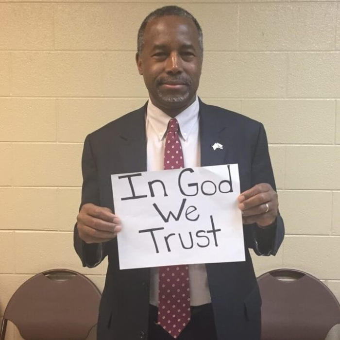 Ben Carson holding a 'In God We Trust' sign in a photo posted on January 19, 2015.