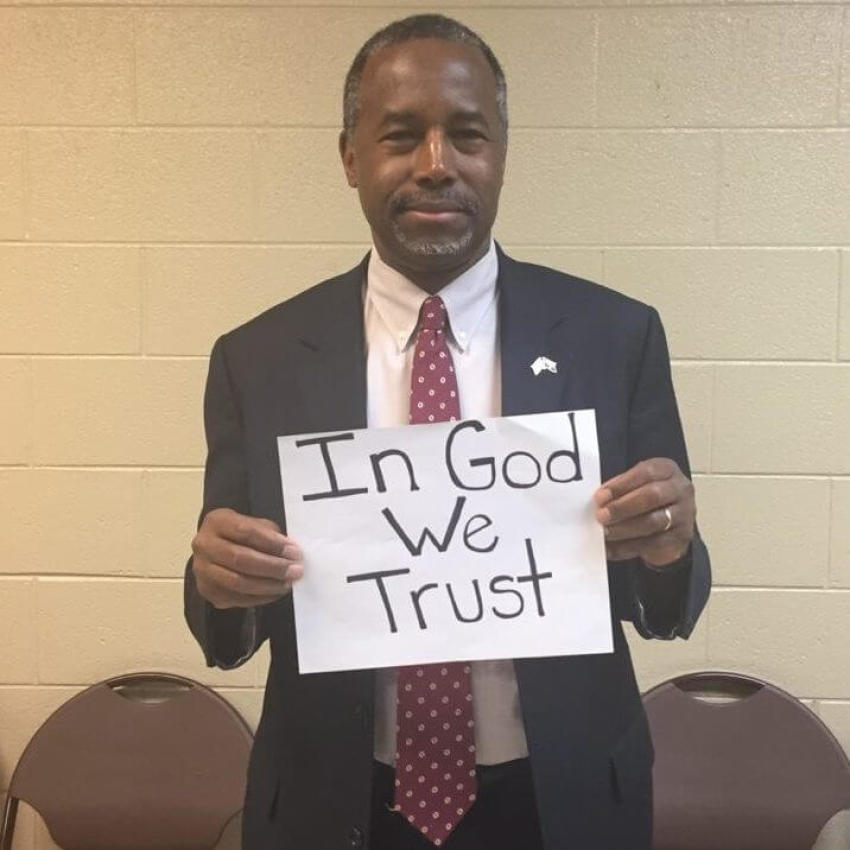 Ben Carson holding a "In God We Trust" sign in a photo posted on January 19, 2015.