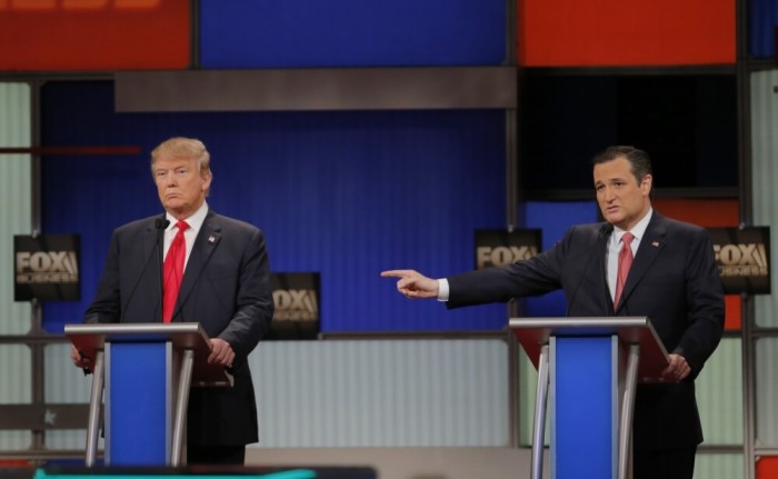 Republican U.S. presidential candidate Senator Ted Cruz gestures towards rival candidate businessman Donald Trump (L) as he speaks at the Fox Business Network Republican presidential candidates debate in North Charleston, South Carolina January 14, 2016.