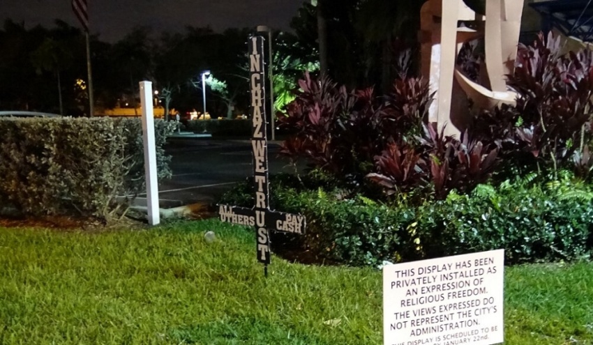 Atheist activist Chaz Stevens places upside down "Satanic Cross" on the property of the city hall of City of Hallandale Beach, Florida.