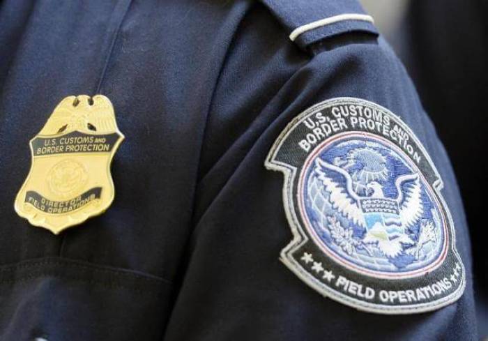 A U.S. Customs and Border Protection arm patch and badge.