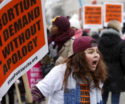 A pro-abortion activist yells at pro-life supporters (not pictured) in front of the Supreme Court during the National March for Life rally in Washington January 22, 2016. 