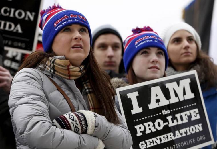 (L-R) Pro-life supporters Marian Rumley, Taylor Miller and Sophie Caticchio from Minnesota listen to speeches at the National March for Life rally in Washington January 22, 2016. The rally marks the 43rd anniversary of the U.S. Supreme Court's 1973 abortion ruling in Roe v. Wade.