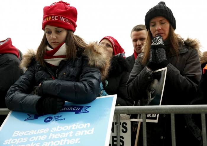 Anti abortion supporters pray at the National March for Life rally in Washington January 22, 2016. The rally marks the 43rd anniversary of the U.S. Supreme Court's 1973 abortion ruling in Roe v. Wade.