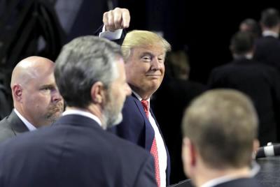 U.S. Republican presidential candidate Donald Trump points to Liberty University President Jerry Falwell, Jr. after speaking in Lynchburg, Virginia, January 18, 2016.