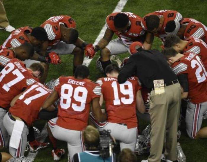 Ohio State Buckeyes team members circle for prayer prior to the game against the Oregon Ducks in the 2015 CFP National Championship Game at AT&T Stadium in this file photo from January 12, 2015.