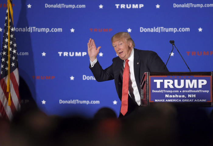 U.S. Republican presidential candidate Donald Trump pantomimes a candidate with low poll numbers as he address the audience at a campaign rally in Nashua, New Hampshire January 29, 2016.