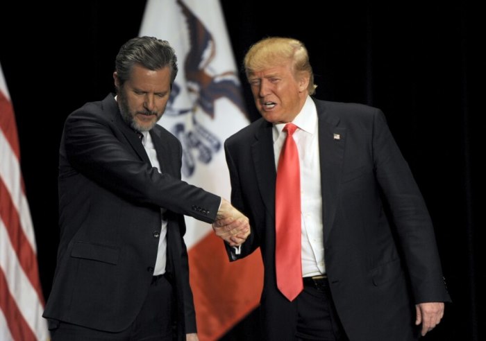 U.S. Republican presidential candidate Donald Trump (R) shakes hands with co-headliner Jerry Falwell Jr., leader of the nation’s largest Christian university, during a campaign event at the Orpheum Theatre in Sioux City, Iowa January 31, 2016.