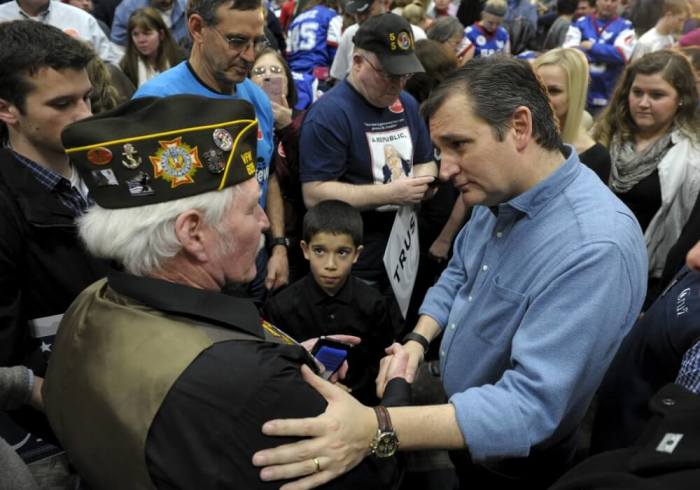 U.S. Republican presidential candidate Senator Ted Cruz tries to answer a veteran's question after a campaign event at the Western Iowa Tech Community College in Sioux City, Iowa January 30, 2016.