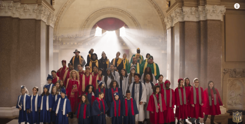 Choirs of people born nine months after the Super Bowl sing a parody of "Kiss From a Rose."