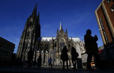 People are silhouetted against the famous landmark the Cologne Cathedral, Germany, January 25, 2016.