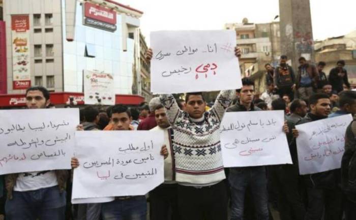 Egyptian Christians hold placards during a protest against the killing of Egyptian Coptic Christians by militants of the Islamic State in Libya, in Cairo February 16, 2015.