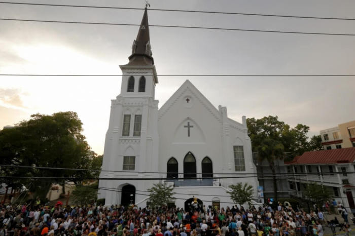 A crowd gathers outside the Emanuel African Methodist Episcopal Church after a prayer vigil nearby in Charleston, South Carolina, June 19, 2015.