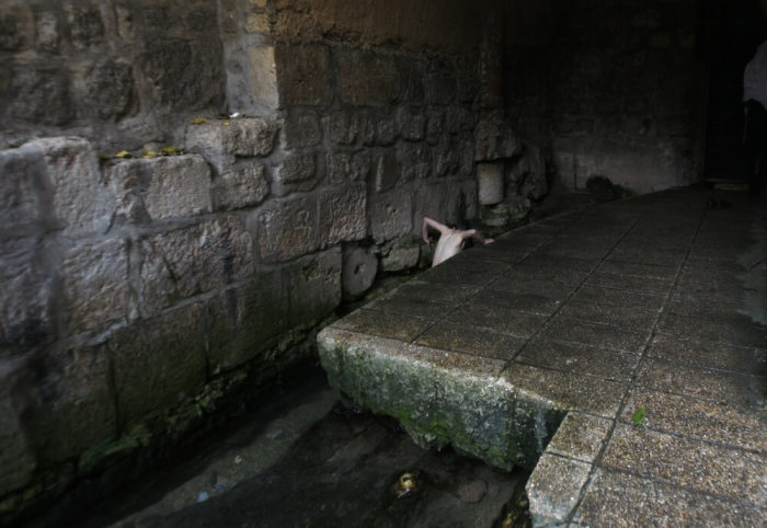 An ultra-Orthodox Jewish man bathes in the Siloam pool in the East Jerusalem neighbourhood of Silwan October 23, 2009. The pool standing today dates the Byzantine Era and is located at the site where Christians believe that Jesus instructed a blind man to wash, granting him sight.