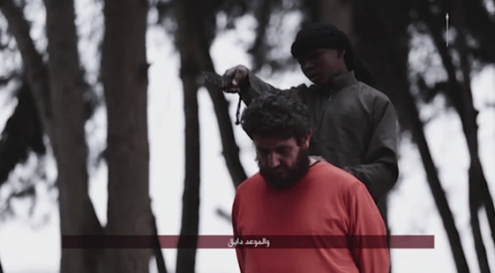 An English-speaking child soldier issues threats toward the United States and other Western nations before beheading a prisoner of the Islamic State in an execution video that was believed by produced by the terrorist group in Aleppo, Syria.