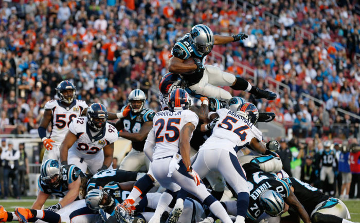 Carolina Panthers' Jonathan Stewart (28) leaps over the goal line to score a touchdown against the Denver Broncos during the NFL's Super Bowl 50 football game in Santa Clara, California California February 7, 2016.