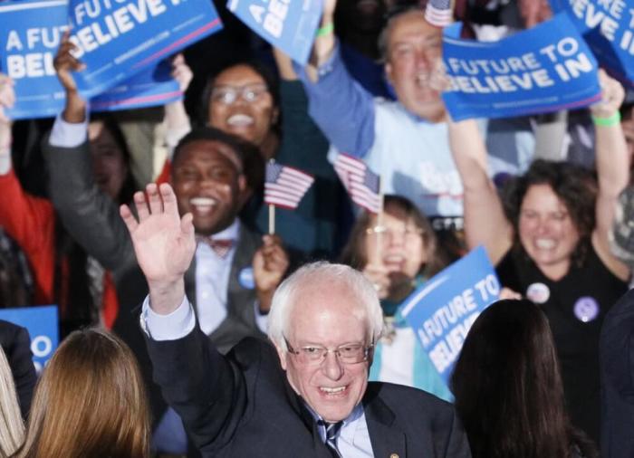 Democratic U.S. presidential candidate Bernie Sanders waves after winning at his 2016 New Hampshire presidential primary night rally in Concord, New Hampshire February 9, 2016.