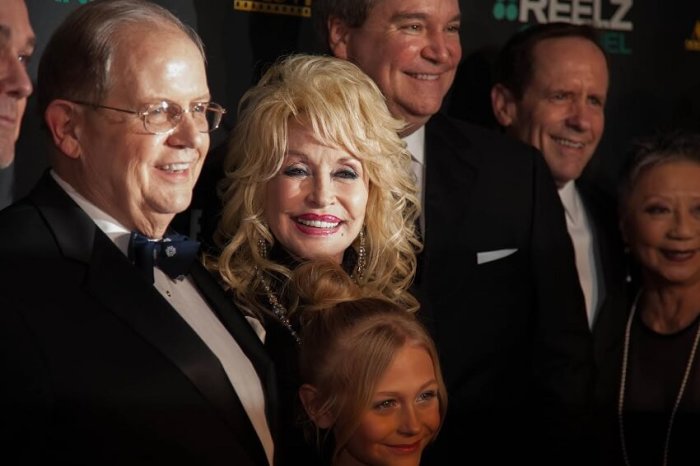 Dolly Parton during the red carpet ceremony with Movieguide founder Ted Baehr (L) and 8-year-old actress Alyvia Alyn Lind, who plays a young Parton in Coat of Many Colors.