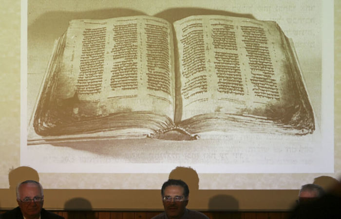 A picture depicting the 10th century Aleppo Codex is displayed during a news conference at Jerusalem's Yad Ben-Zvi institute December 2, 2007. The institute said last month that a 1,000-year-old parchment, the size of a credit card, forms part of the Aleppo Codex, viewed by scholars as one of the most authoritative manuscripts of the Hebrew Bible. The parchment was kept as a lucky charm by Sam Sabbagh, a Syrian Jew who in 1947 plucked it from the floor of an Aleppo synagogue that was torched after a United Nations decision to partition Palestine, paving the way for the creation of Israel.