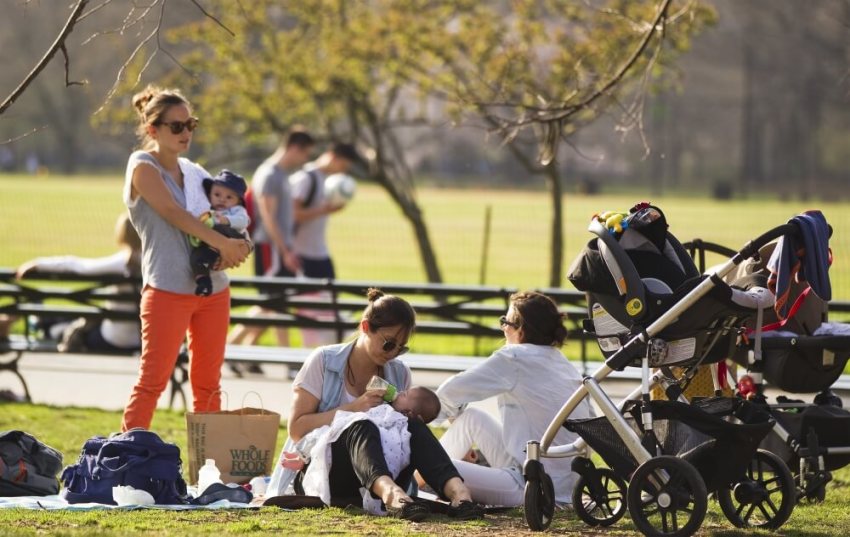 Credit : Mothers relax on the grass with their babies at Central Park during a warm day in New York, March 22, 2012.