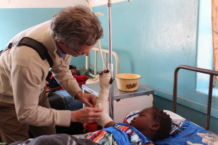 The Rev. Dr. Paul Osteen treats a child during a medical mission in far western Zambia where he visited Mukinge and Chitokoloki Hospitals.