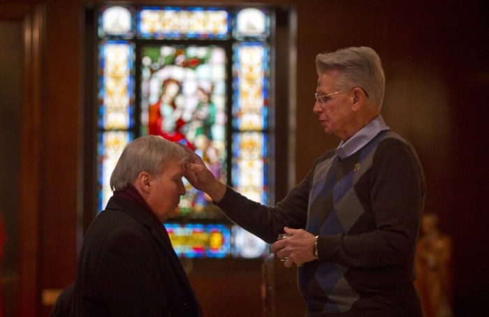 A woman receives ashes at St. Andrew's church in observance of Ash Wednesday in the Manhattan borough of New York, March 5, 2014. 