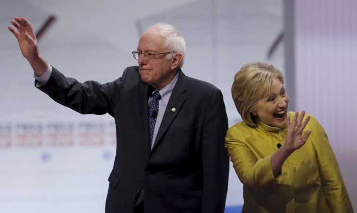 Democratic U.S. presidential candidates Senator Bernie Sanders and former Secretary of State Hillary Clinton wave as they arrive on stage before of the start of the PBS NewsHour Democratic presidential candidates debate in Milwaukee, Wisconsin, February 11, 2016.
