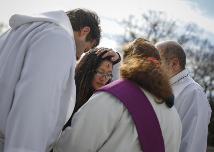 A woman receives ashes in observance of Ash Wednesday from clergy of the Gustavus Adolphus Lutheran Church at Union Square in New York, March 5, 2014. Christians celebrated Ash Wednesday, which serves as a reminder that "as a man is dust, so unto dust he shall return" and marked the beginning of a 40-day period of Lent in the Roman Catholic calendar.