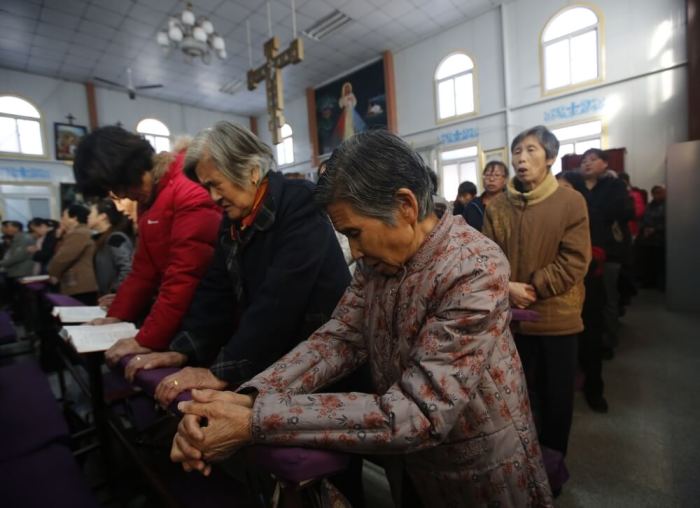 Believers take part in a weekend mass at an underground Catholic church in Tianjin, China, November 10, 2013.