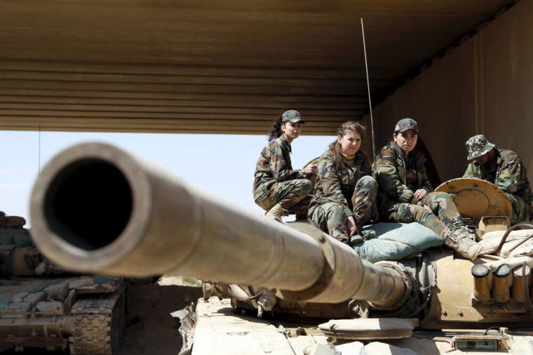 Members of a Female Commando Battalion which is part of the Syrian Army, sit atop of a tank in the government-controlled area of Jobar, a suburb of Damascus March 19, 2015. This Battalion consists of several hundred female fighters who have had military training and carry out combat duties. Picture taken during a Syrian Army organised trip.