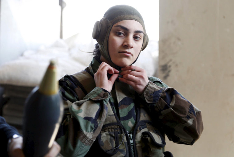 A member of a Female Commando Battalion which is part of the Syrian Army, wears her headgear in the government-controlled area of Jobar, a suburb of Damascus March 19, 2015. This Battalion consists of several hundred female fighters who have had military training and carry out combat duties. Picture taken during a Syrian Army organised trip.