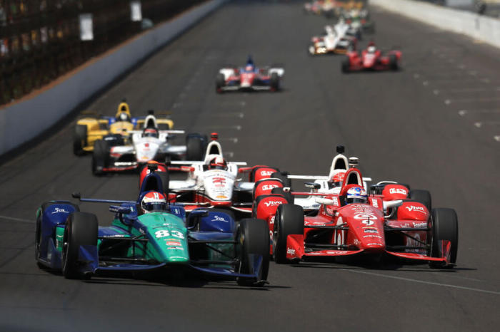 IndyCar Series driver Charlie Kimball (83) leads Scott Dixon (9) during the 2015 Indianapolis 500 at Indianapolis Motor Speedway.