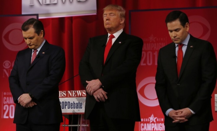 Republican U.S. presidential candidates (L-R) Senator Ted Cruz, businessman Donald Trump and Senator Marco Rubio pause for a moment of silence in honor of deceased Supreme Court Associate Justice Antonin Scalia before the start of the Republican U.S. presidential candidates debate sponsored by CBS News and the Republican National Committee in Greenville, South Carolina February 13, 2016.