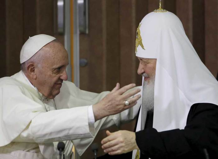 Pope Francis, left, reaches to embrace Russian Orthodox Patriarch Kirill after signing a joint declaration at the Jose Marti International airport in Havana, Cuba, Friday, February 12, 2016.