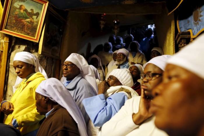 Nigerian pilgrims pray inside the Church of the Nativity during Christmas celebrations in the West Bank town of Bethlehem, December 24, 2015.