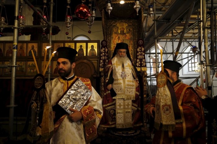 The Greek Orthodox Patriarch of Jerusalem Theophilos III (C) attends a Christmas service according to the Eastern Orthodox calendar, in the Church of Nativity in the West Bank city of Bethlehem, January 6, 2016.