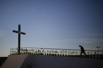 A member of Vatican security inspects the cross where Pope Francis will celebrate a mass in Ciudad Juarez, February 16, 2016.