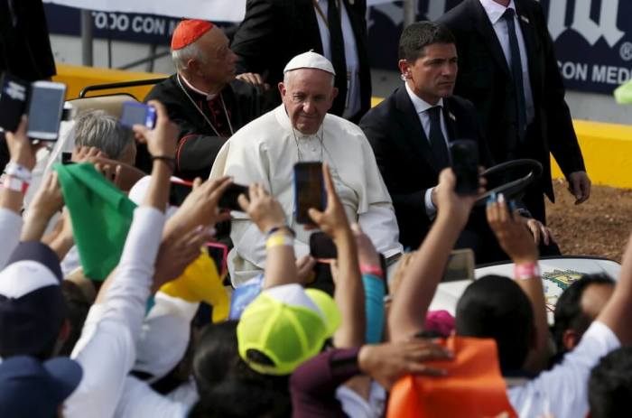 People take photographs of Pope Francis (C) during a meeting with youths at the Jose Maria Morelos y Pavon stadium in Morelia, Mexico, February 16, 2016.