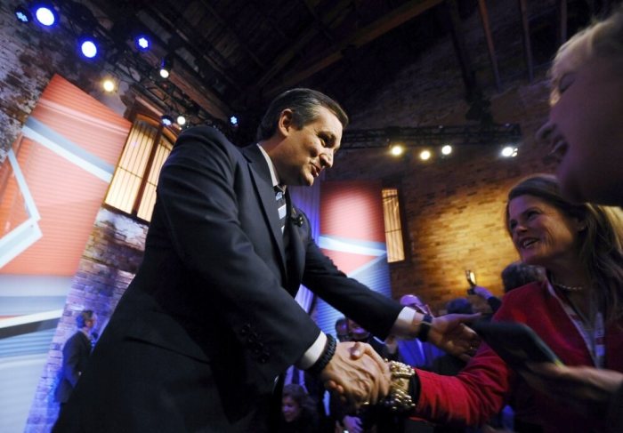 U.S. Republican presidential candidate Ted Cruz greets supporters during a commercial break in a campaign town hall hosted by CNN in Greenville, South Carolina February 17, 2016.