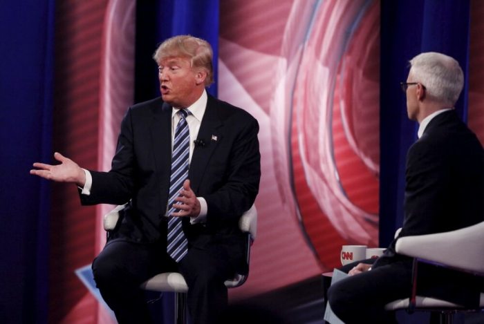 U.S. Republican presidential candidate Donald Trump (L) speaks with the audience as presenter Anderson Cooper looks on at the South Carolina Republican Presidential Town Hall sponsored by CNN in Columbia, South Carolina, February 18, 2016.