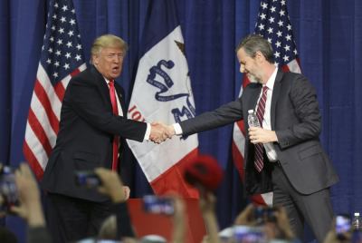 U.S. Republican presidential candidate Donald Trump (L) shakes hands with Jerry Falwell Jr. at a campaign rally in Council Bluffs, Iowa, January 31, 2016.