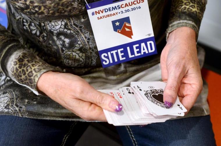 Chair of the Douglas County Democrats, Kimi Cole of Minden, Nevada, prepares to shuffle a deck of cards while caucusing at Douglas High School in Minden, Nevada February 20, 2016. When precincts are tied for the loss or gain of a delegate in Nevada, a high card draw determines which candidate gets the delegate.
