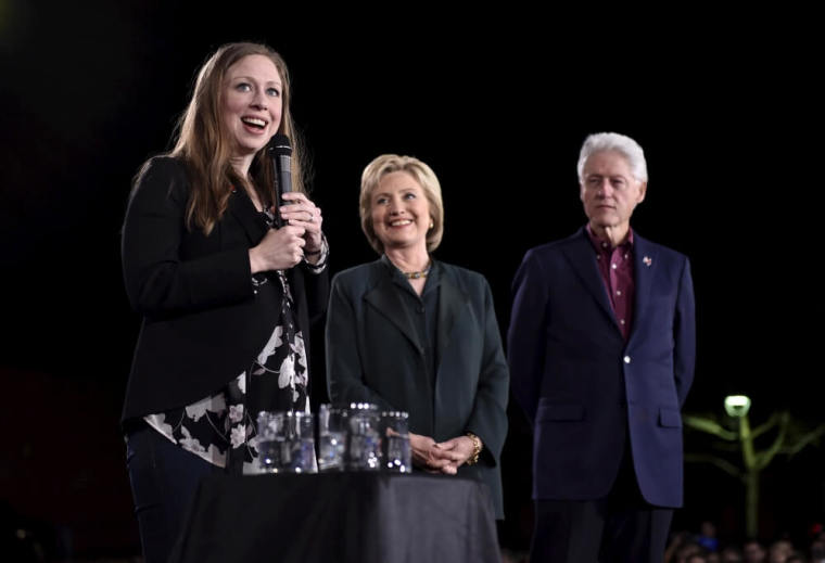 Chelsea Clinton (L) speaks as U.S. Democratic presidential candidate Hillary Clinton and former President Bill Clinton look on at a campaign rally at the Clark County Government Center in Las Vegas, Nevada, February 19, 2016.