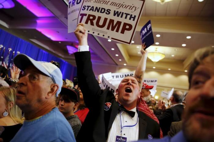 Supporters of U.S. Republican presidential candidate Donald Trump celebrate the close of the polls as they watch election results at a rally in Spartanburg, South Carolina, February 20, 2016.