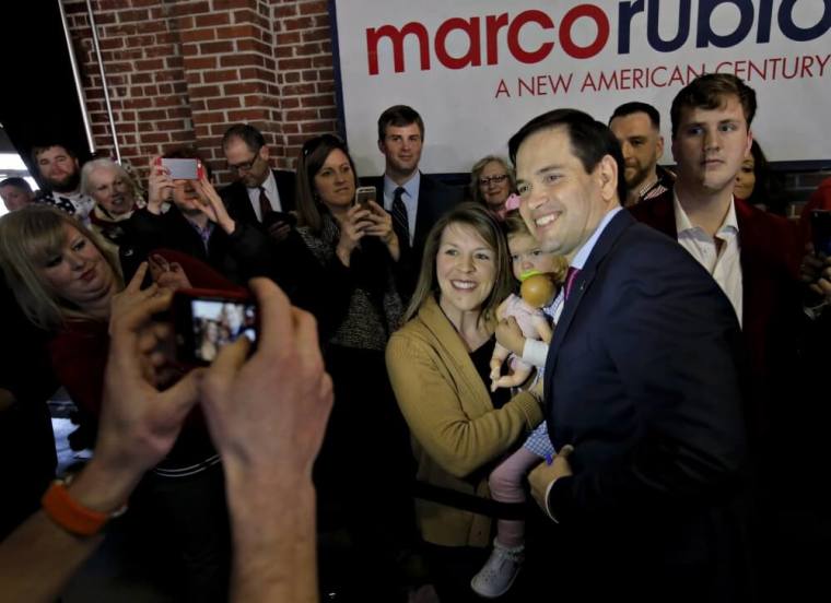 U.S. Republican presidential candidate Marco Rubio takes a picture with a supporter during a campaign event at Swamp Rabbit Crossfit in Greenville, South Carolina, February 18, 2016.