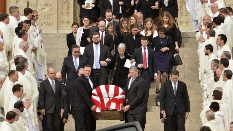 Pallbearers carry the casket of Supreme Court Associate Justice Antonin Scalia out of his funeral Mass as his widow Maureen and other family members follow, February 20, 2016.