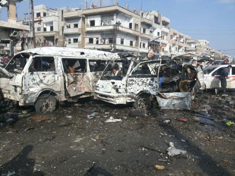 Damaged buses are seen at the site of two bomb blasts in the government-controlled city of Homs, Syria, in this handout picture provided by SANA on February 21, 2016.