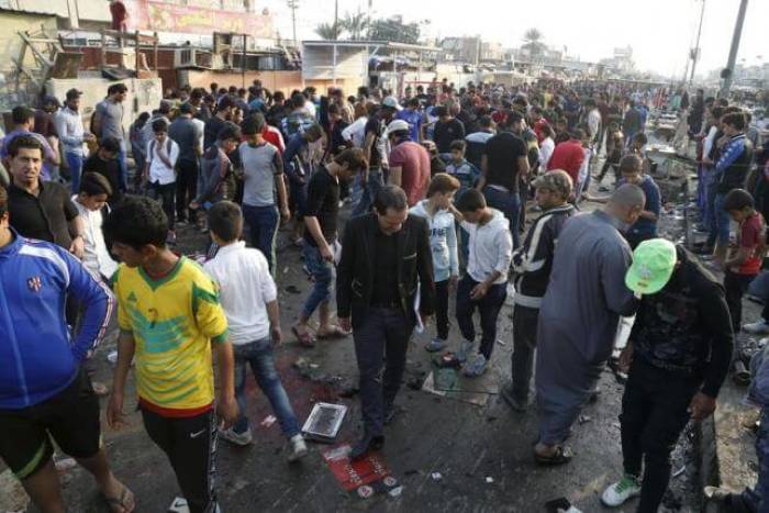 People gather at the site of suicide blasts in Baghdad's Sadr City February 28, 2016. The death toll from two suicide blasts in Baghdad's mainly Shi'ite district of Sadr City rose to 24 with more than 60 others wounded, police and medical sources said on Sunday.